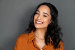 A woman smiling and showing the results of teeth whitening in Spokane