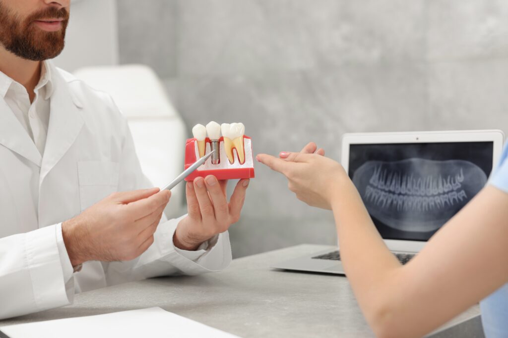 A dentist explaining dental implants and bone grafting to a patient
