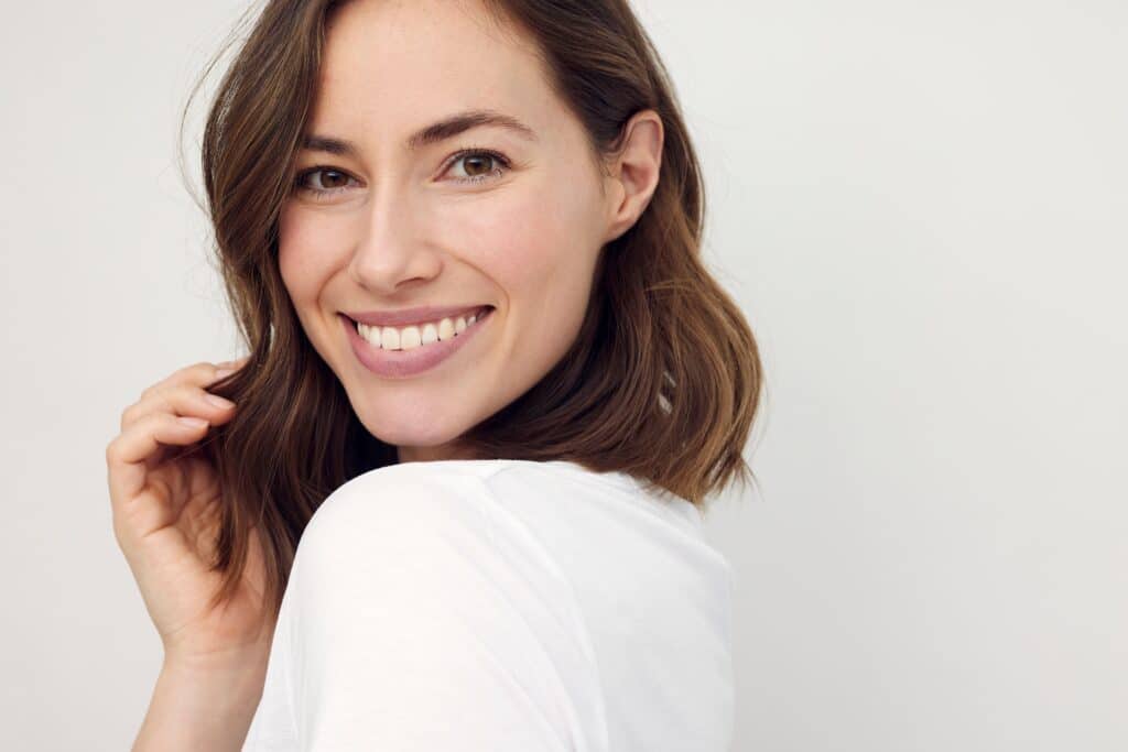 A woman smiling after getting a dental bridge in Spokane, WA